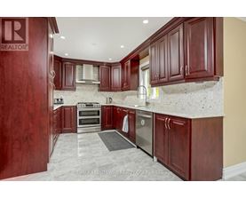 A kitchen with wooden cabinets and a stainless steel dishwasher.