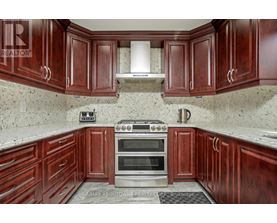 A kitchen with wooden cabinets and a stove top oven.