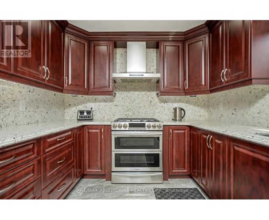 A kitchen with wooden cabinets and a stove top oven.