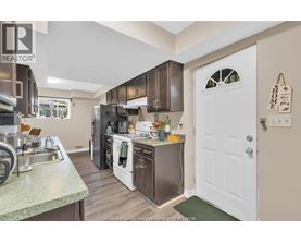 A kitchen with a sink, stove, and refrigerator.