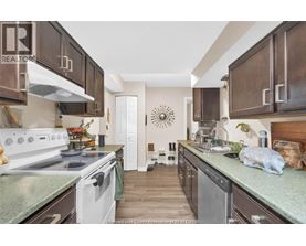 A kitchen with white appliances and brown cabinets.