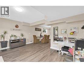A living room with a white couch and a wooden floor.