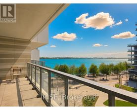 A balcony overlooks a beach and a body of water.