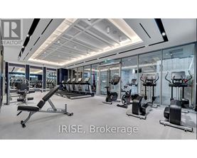 A gym with a variety of equipment including treadmills, stationary bikes, and weight machines.