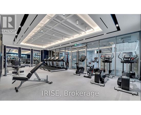 A gym with a variety of equipment including treadmills, stationary bikes, and weight machines.