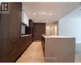 A modern kitchen with dark wood cabinets and a white countertop.