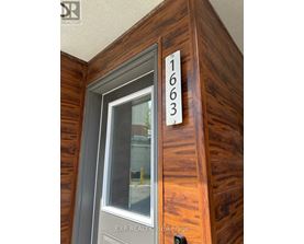 A wooden door with the number 1663 on it.
