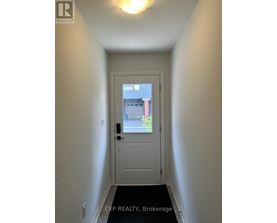 A white door with a black handle and a window above it.