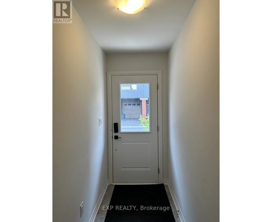 A white door with a black handle and a window above it.