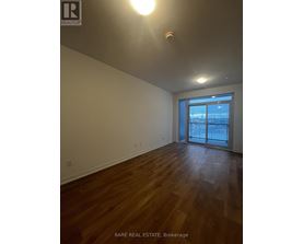 A room with wood flooring and a sliding glass door.