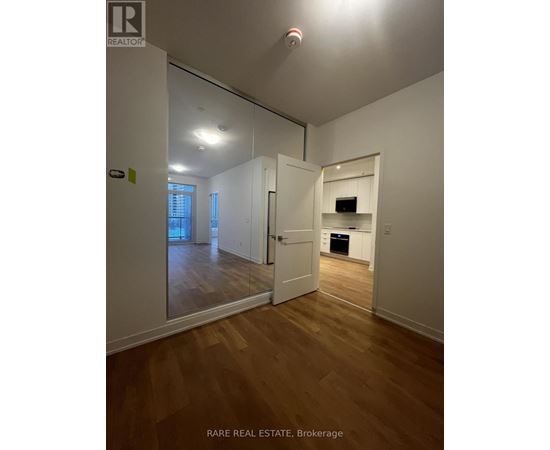 A brokerage sign is on the wall in a white room.
