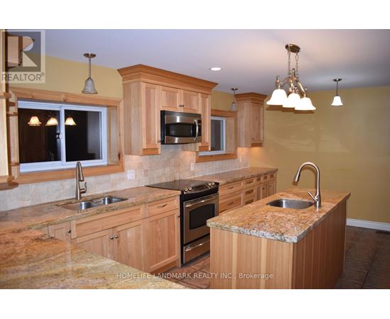 A kitchen with wooden cabinets and granite countertops.
