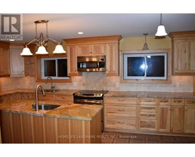 A kitchen with wooden cabinets and granite countertops.