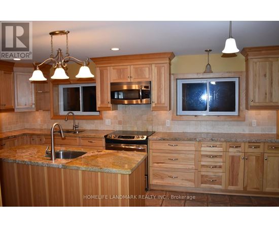 A kitchen with wooden cabinets and granite countertops.
