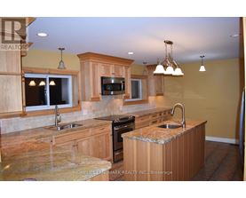 A kitchen with wooden cabinets and granite countertops.