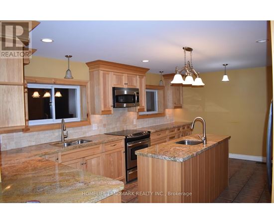 A kitchen with wooden cabinets and granite countertops.
