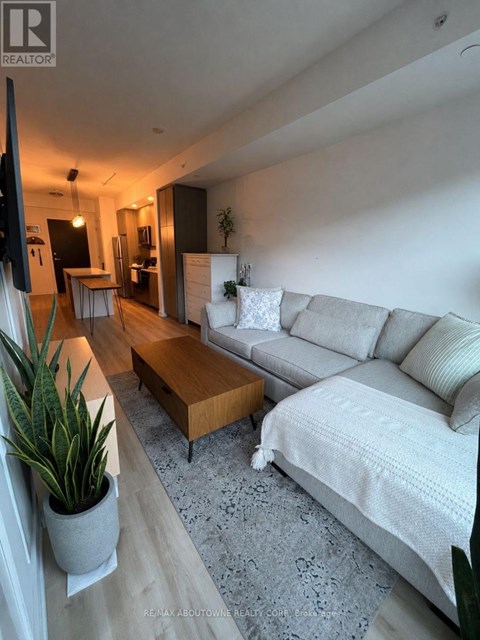 A living room with a grey couch and a wooden coffee table.