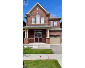 A red brick house with a white garage door.
