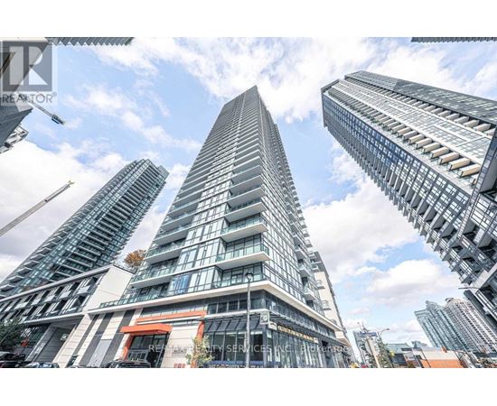 A tall building with a curved facade stands out among other skyscrapers.