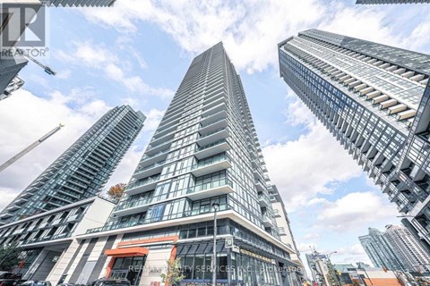 A tall building with a curved facade stands out among other skyscrapers.