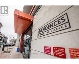 The front of a building with a sign that says Residences at Parkside Village.