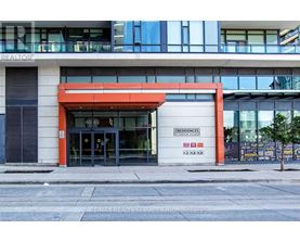 The front of a building with a large glass window and a red awning.