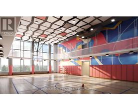 A basketball court with a RE/MAX Success Realty logo on the floor.