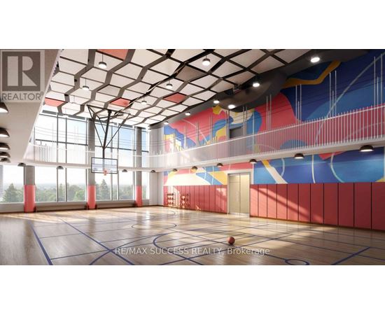 A basketball court with a RE/MAX Success Realty logo on the floor.