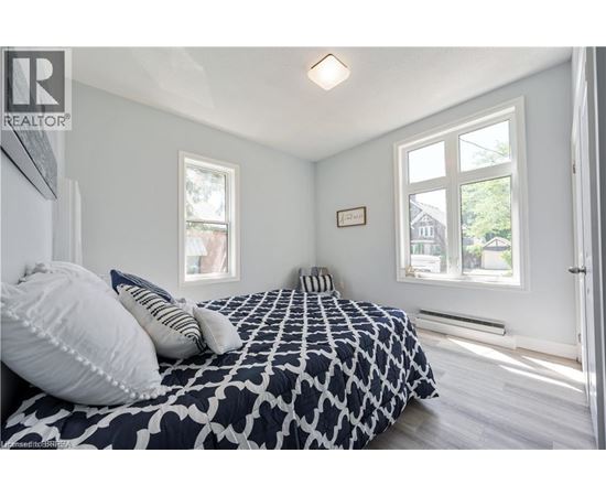 A bedroom with a large bed and a window.