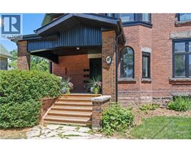 A house with a brick facade and a wooden porch.