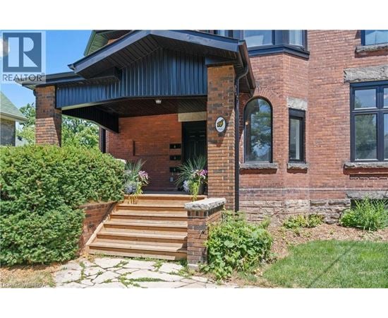 A house with a brick facade and a wooden porch.