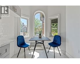A dining room with a table and two chairs.