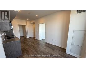 A spacious room with a bar area and a door leading to another room.