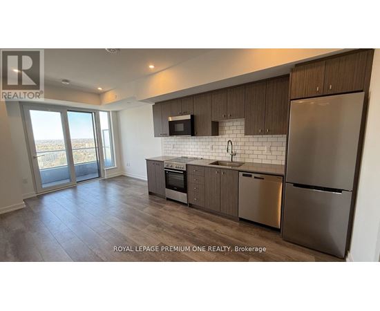 A modern kitchen with stainless steel appliances and wooden cabinets.