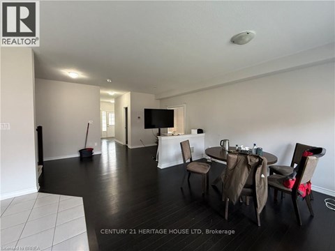 A living room with a dining table set up with chairs.
