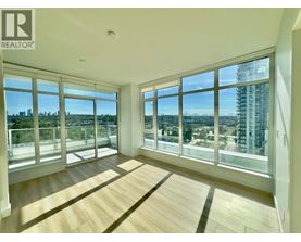 A spacious room with large windows overlooking a cityscape.