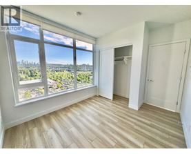 A room with a large window overlooking a cityscape.