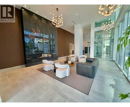 A modern living room with a brown accent wall and a glass door.