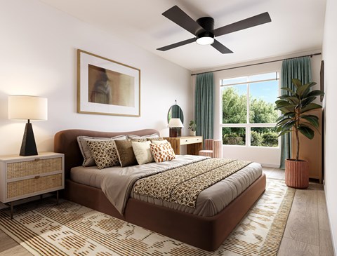 A bedroom with a large bed and a ceiling fan.