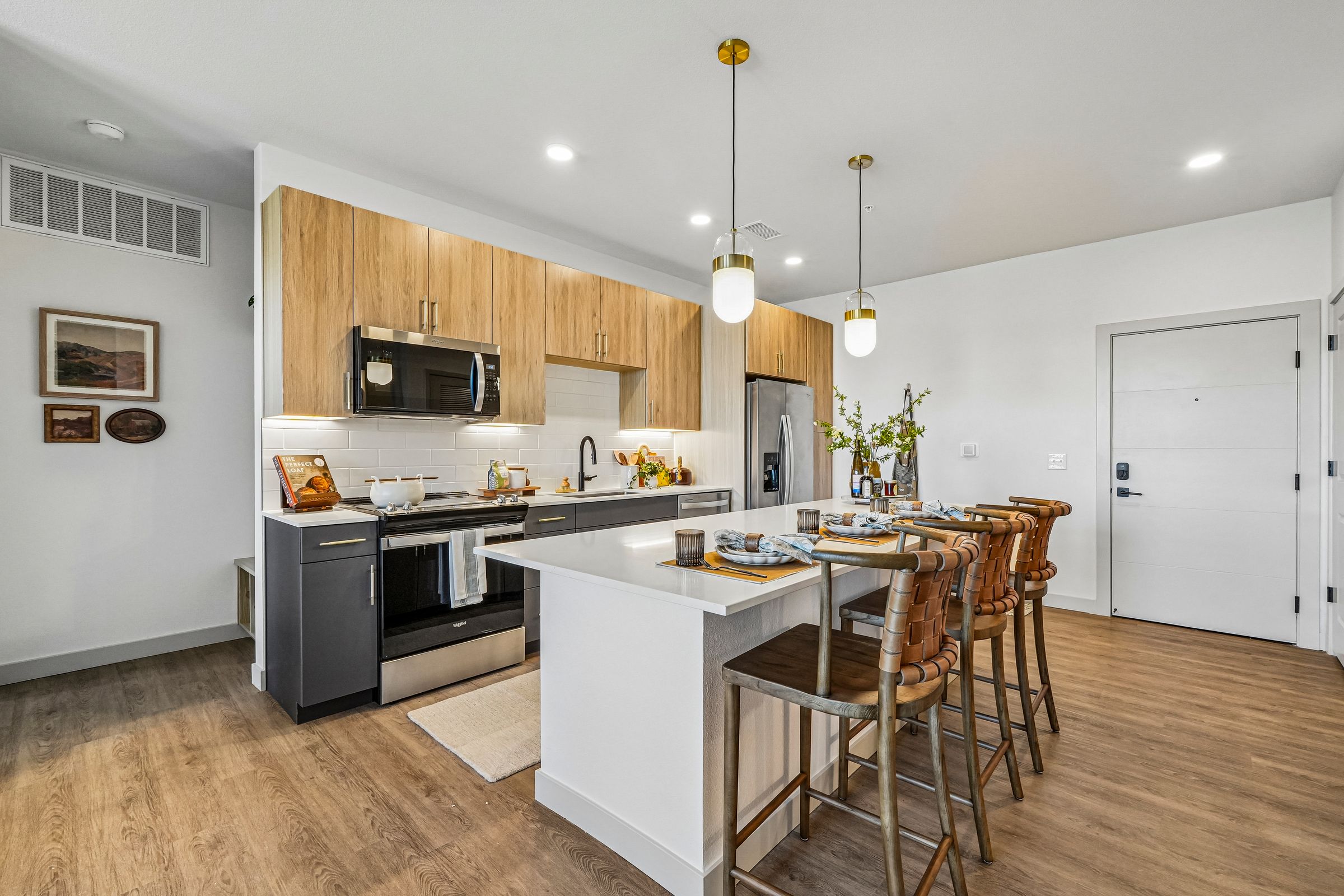 A modern kitchen with wooden cabinets and a white island.