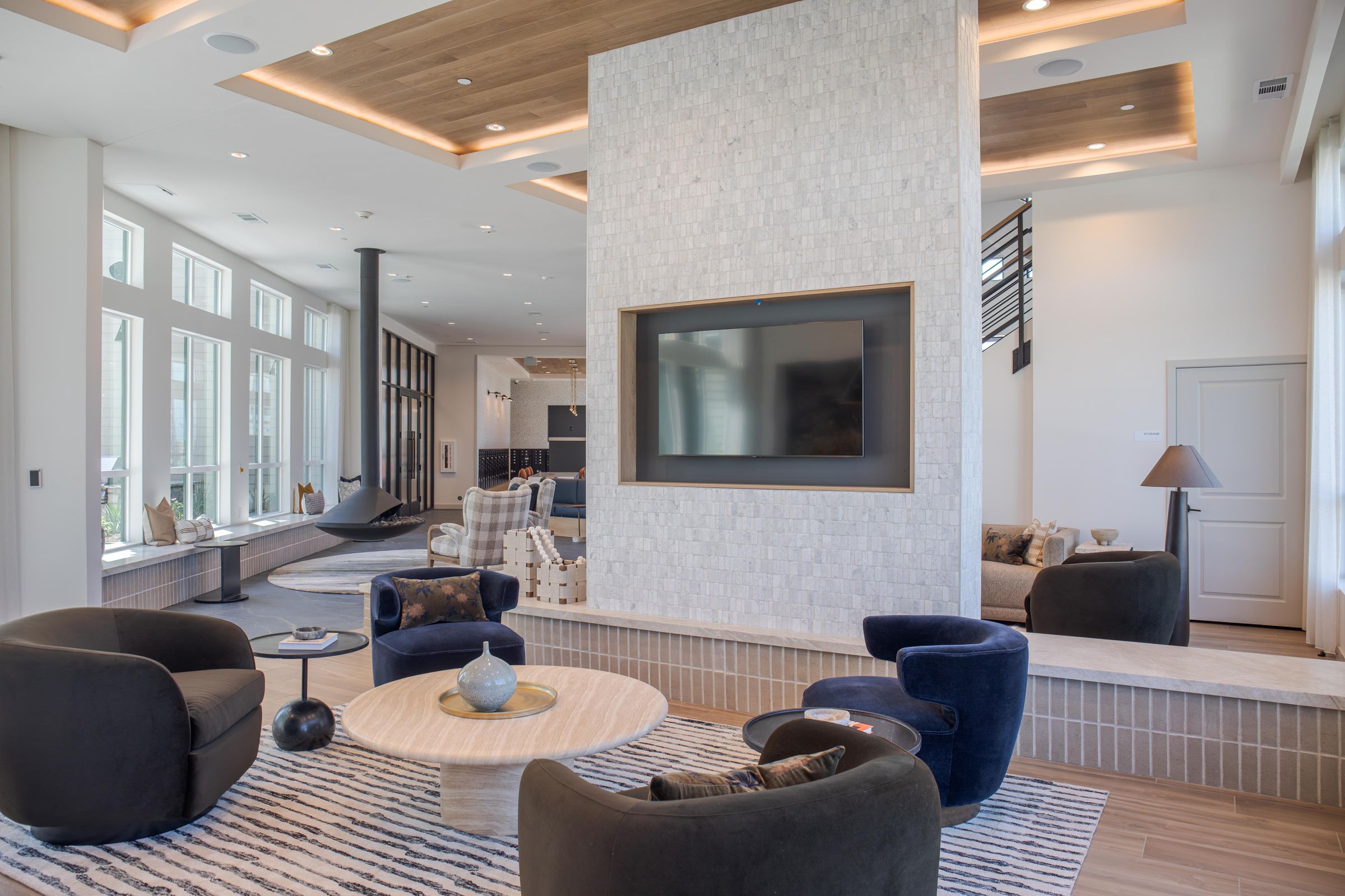 A modern living room with a large television and comfortable seating.