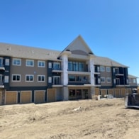 A large building with a lot of windows is under construction.