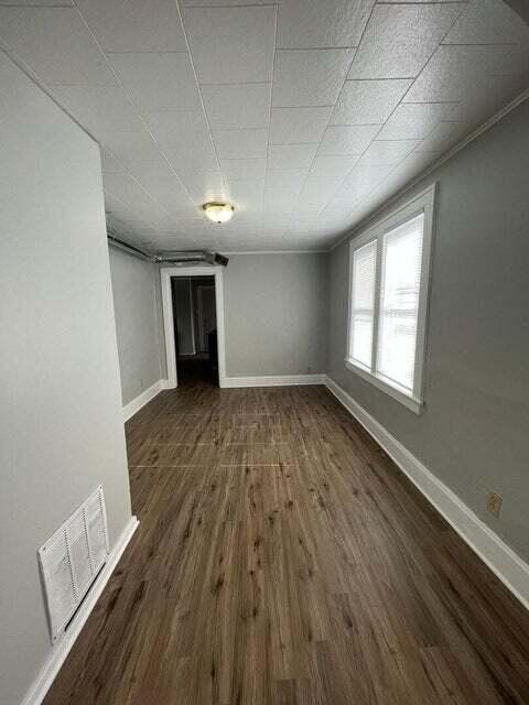 A room with wooden floors and white walls.