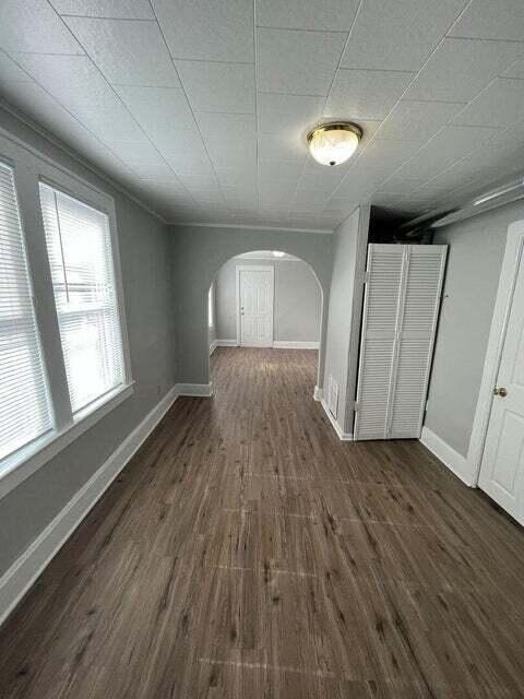 A room with wood flooring and white walls.