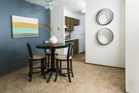 A dining room with a table and chairs.