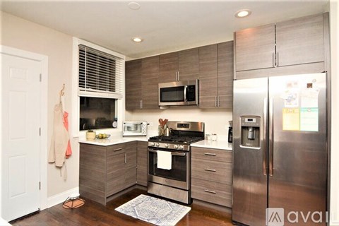 A kitchen with a stove top oven and a microwave above it.