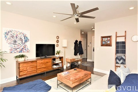 A living room with a wooden coffee table and a flat screen TV.