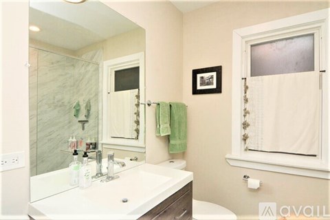 A bathroom with a white sink and a mirror.