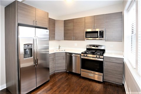 A modern kitchen with stainless steel appliances and wooden cabinets.