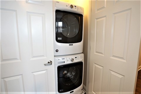 A white dishwasher and microwave are installed in a kitchen.